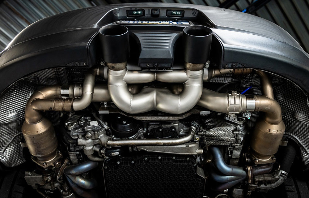 Soul Performance valved x-pipe exhaust system with black tips installed on a Porsche 991.2 on a vehicle lift.
