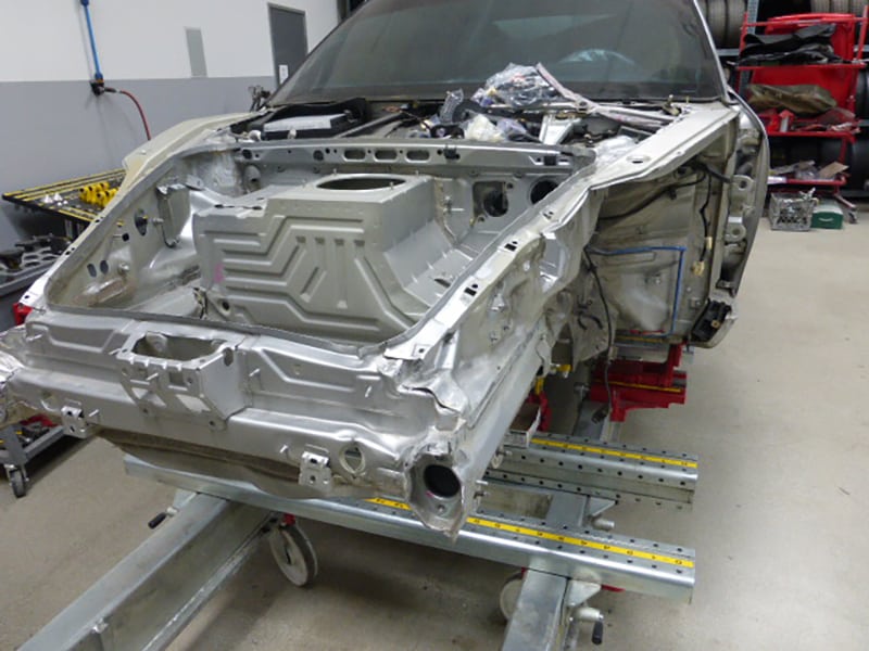 Close-up of a Porsche 996 911 front body panels removed for paint prep.