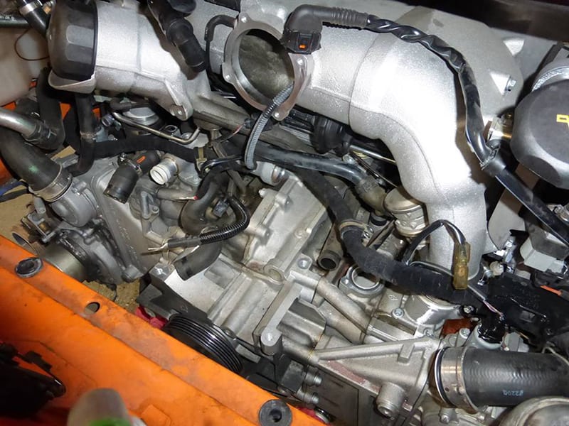 Close-up of a 911 engine with various components and hoses.