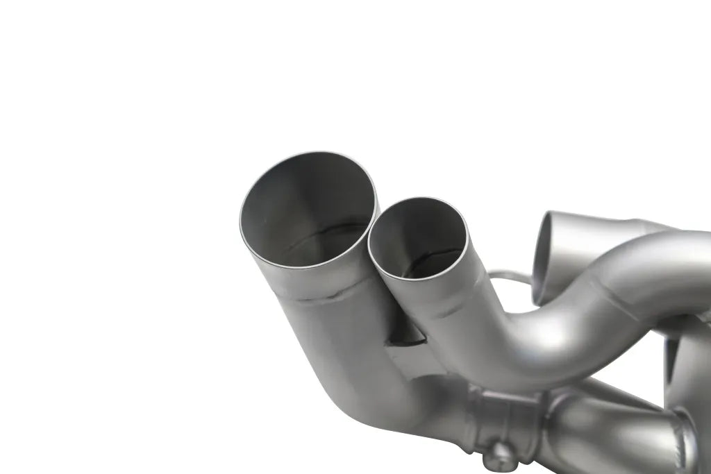 Close up of Soul Performance center muffler exhaust system pipes in silver for Porsche 911 on a white background.