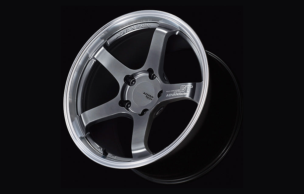 Advan GT for Porsche center lock wheel in Machining & Hyper Platinum Black in black background.