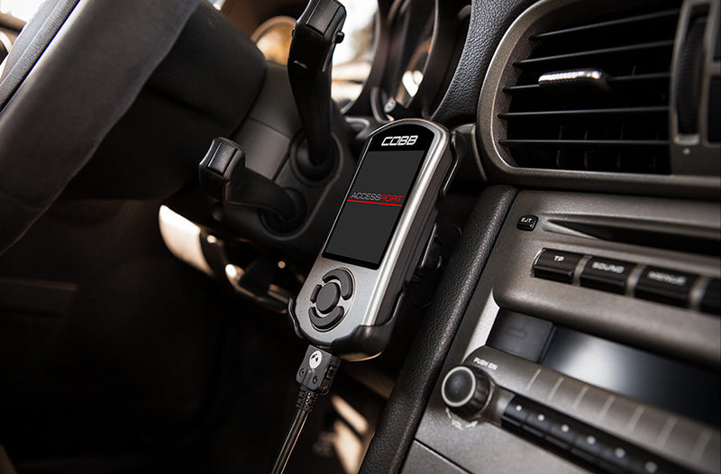 Porsche 997 dashboard with a Cobb Tuning Accessport attached on center console of dash.