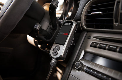 Porsche 997 dashboard with a Cobb Tuning Accessport attached on center console of dash.