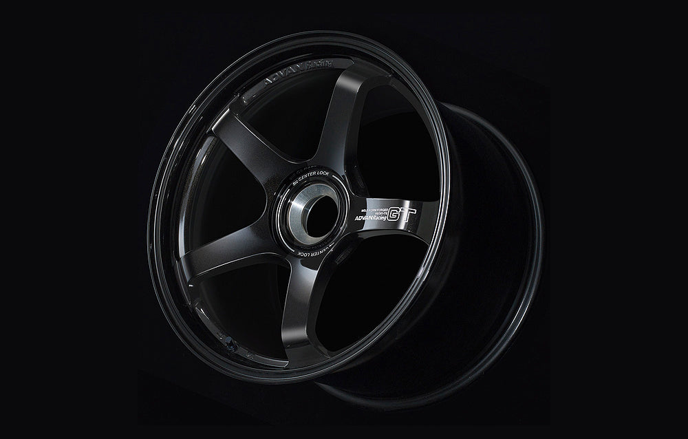 Advan GT for Porsche center lock wheel in Racing Gloss Black in black background.