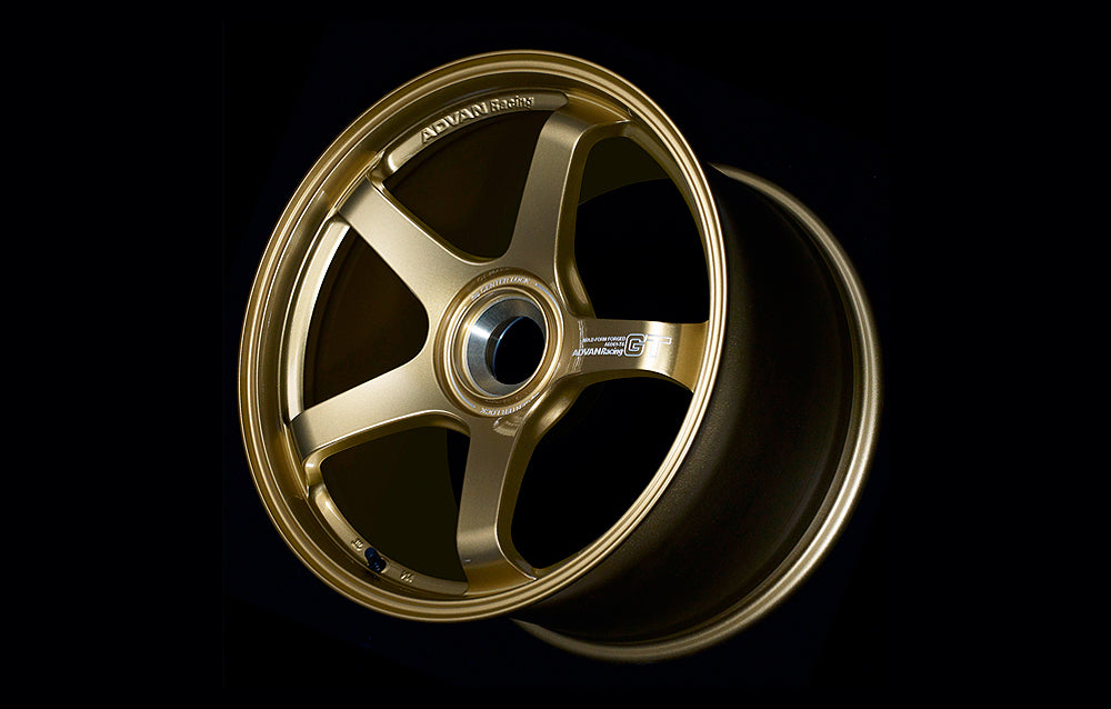 Advan Racing GT for Porsche centerlock in gold in black background.