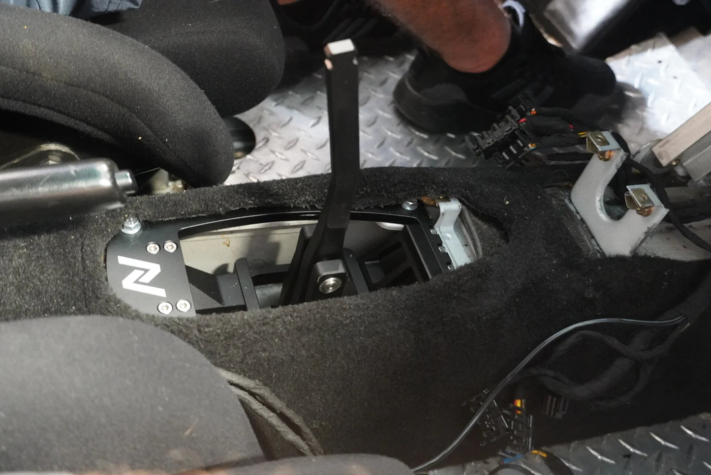 Numeric Short Throw Shifter component in black installed in center transmission tunnel of Porsche 911 race car.