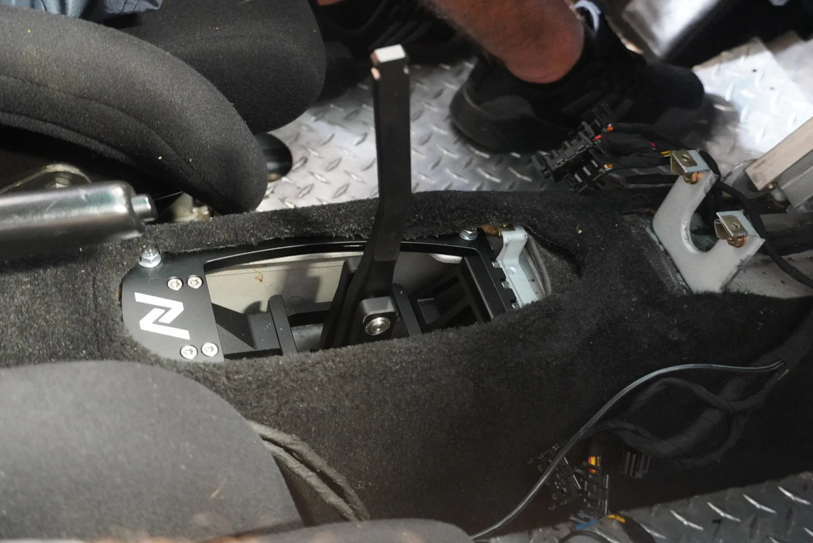 Numeric Short Throw Shifter component in black installed in center transmission tunnel of Porsche 911 race car.