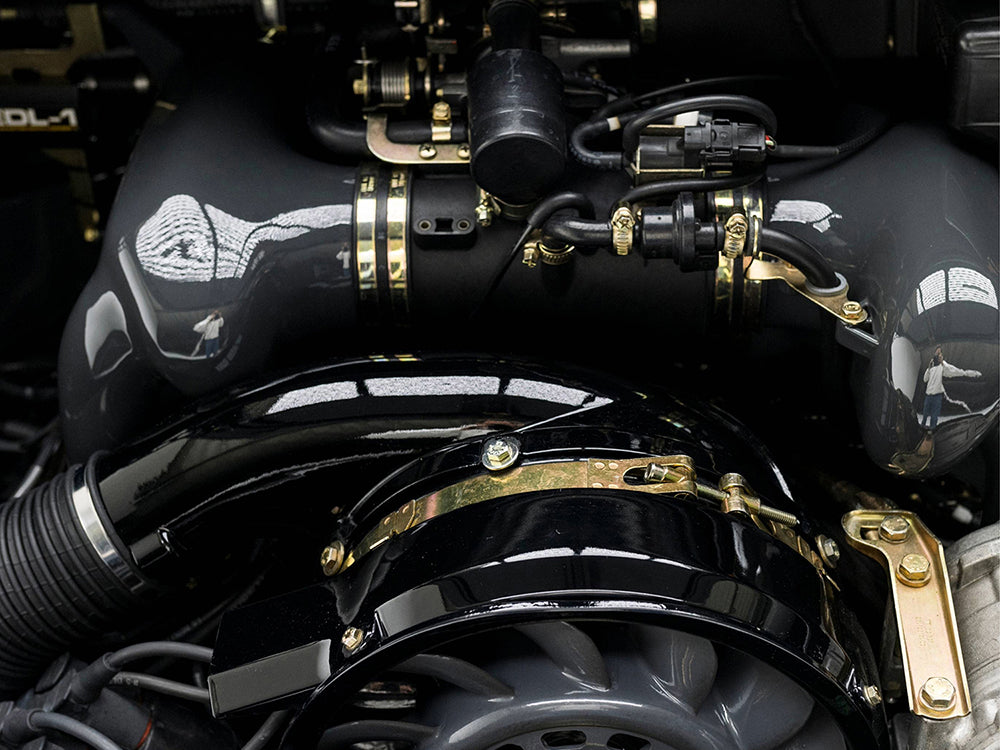 Close-up of a Triebwerk Resonator Pipe installed in Porsche 964 engine.