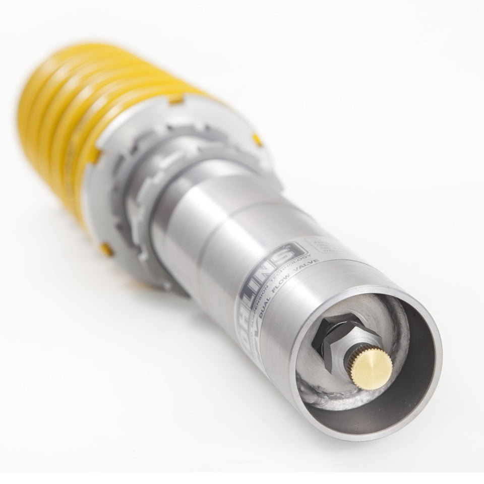 Close-up of Ohlins coilover body showing dual flow valve knob on a white background.