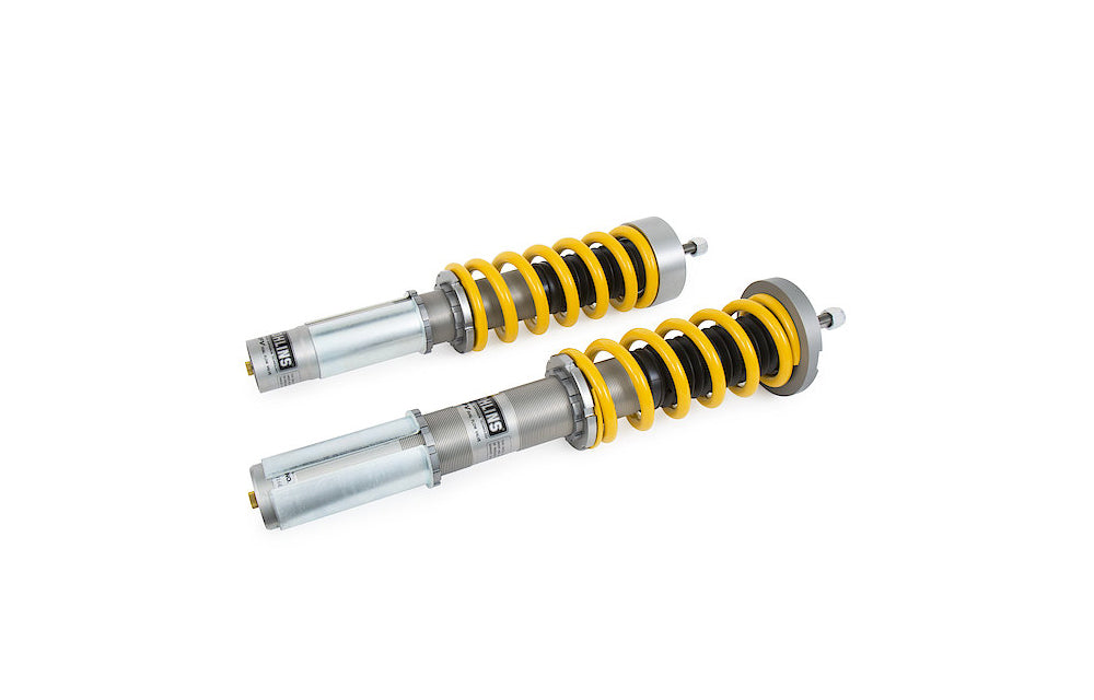 Two Ohlins Road And Track coilovers for Porsche on white background.