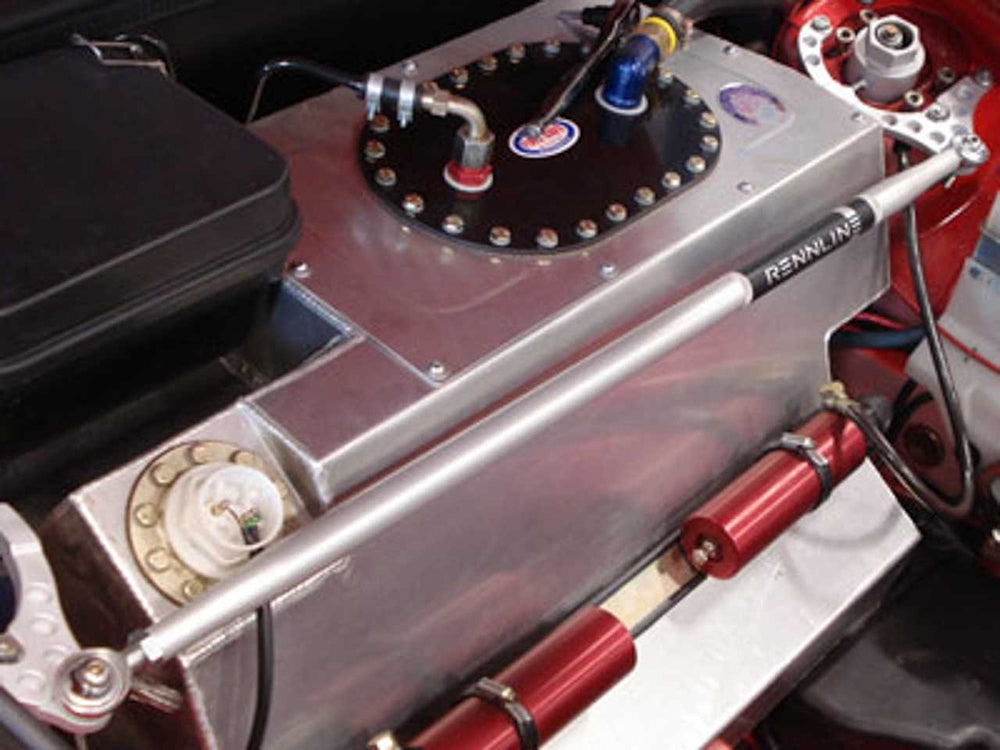 Close-up of a rennline strut bar mount installed in a red Porsche bay.