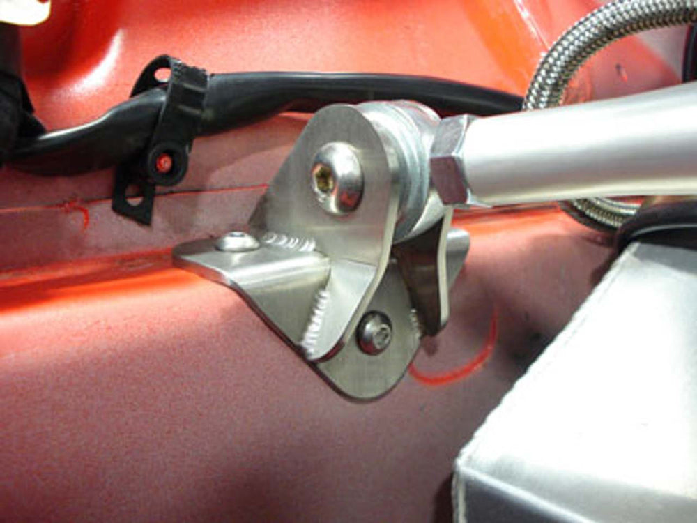 Close-up of a rennline strut bar mount in a red Porsche bay.