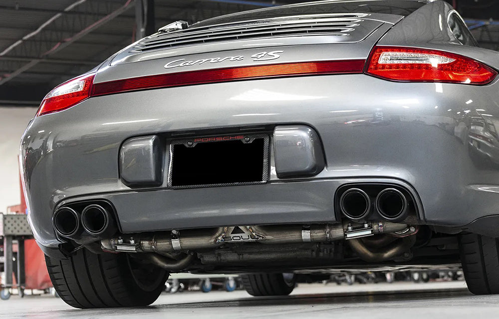Soul performance center muffler bypass exhaust installed on silver Porsche 997.2 C4S inside a garage shop.