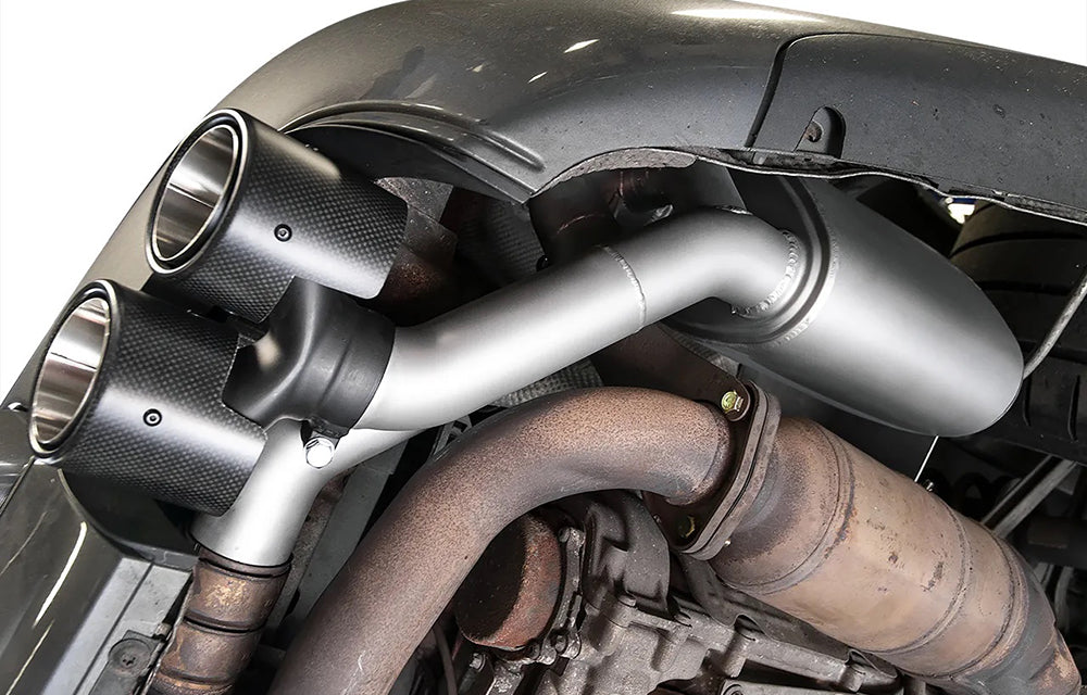 Close-up of a Soul performance side muffler exhaust installed on Porsche.
