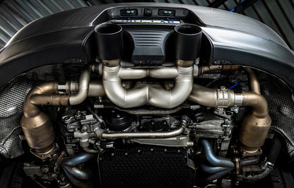 Soul Performance valved x-pipe exhaust system with black tips installed on a Porsche 991.2 on a vehicle lift.