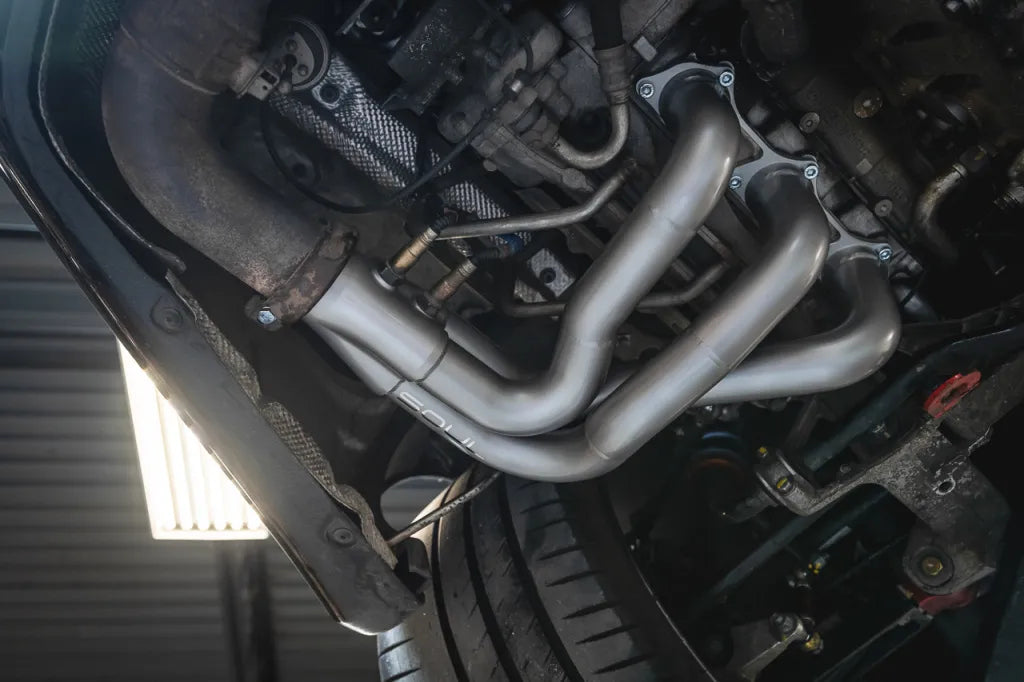Close up of Soul Performance street headers in silver installed on engine of Porsche 911 GT3.