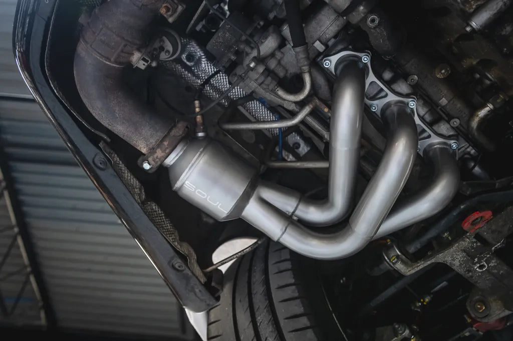 Close-up of a Soul Performance street headers in silver installed on engine for Porsche 997 GT3.