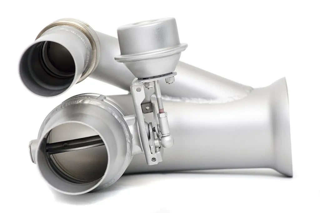 Close up of inlet and outlet Soul Performance side muffler bypass exhaust pipes in silver for Porsche 911 GT3 on a white background.
