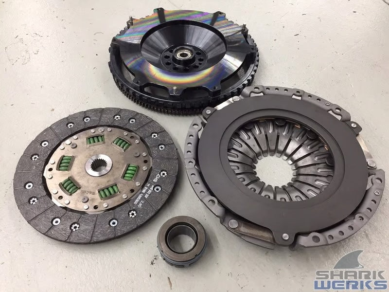 Clutch plates, flywheel, and components on a light background with 'Sharkwerks' logo.