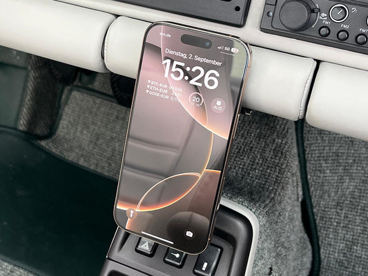 Phone mounted in Triebwerk wireless charging holder in Porsche 964 interior