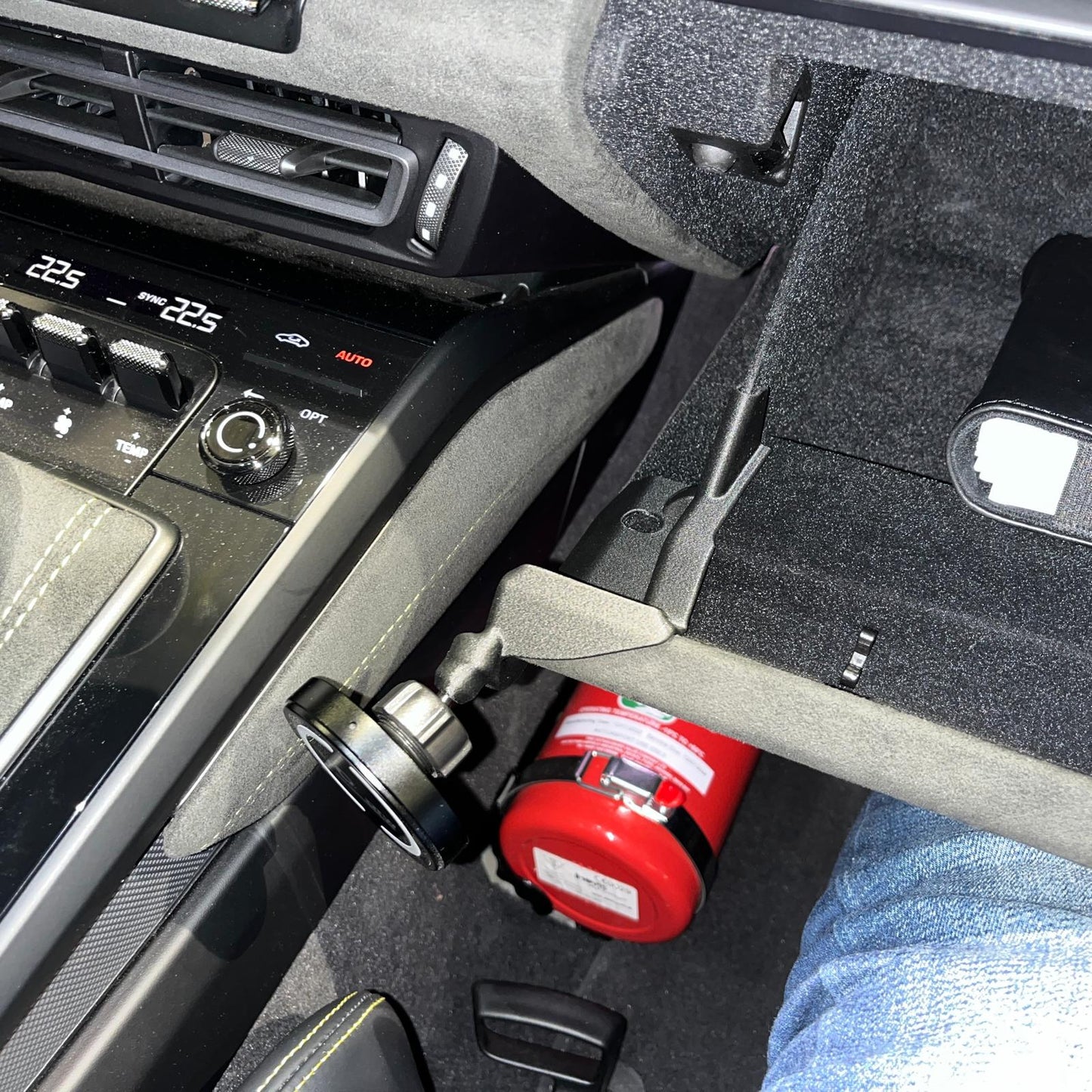 Triebwerk magnetic phone mount installed on corner of glove box of Porsche 992 interior.
