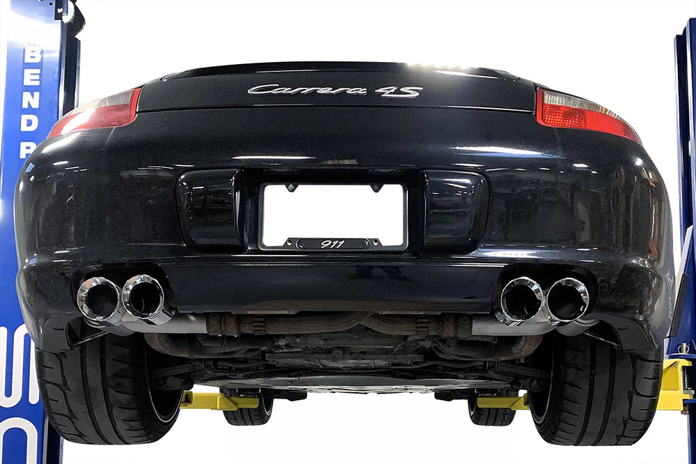 Soul performance sport side mufflers with polished tips installed on black Porsche 997.1 C4S on a garage lift.