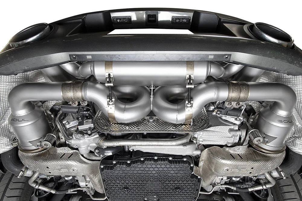 Underside view of Soul valved exhaust system installed on porsche 911 992 carrera.