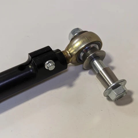 Close up of Tarett Engineering rear upper control arm end link on white table.