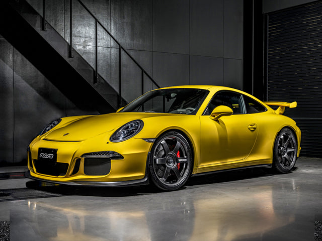 Porsche 991 GT3 yellow with Volk Racing TE37 Saga S-Plus wheel in diamond dark gunmetal in a studio.