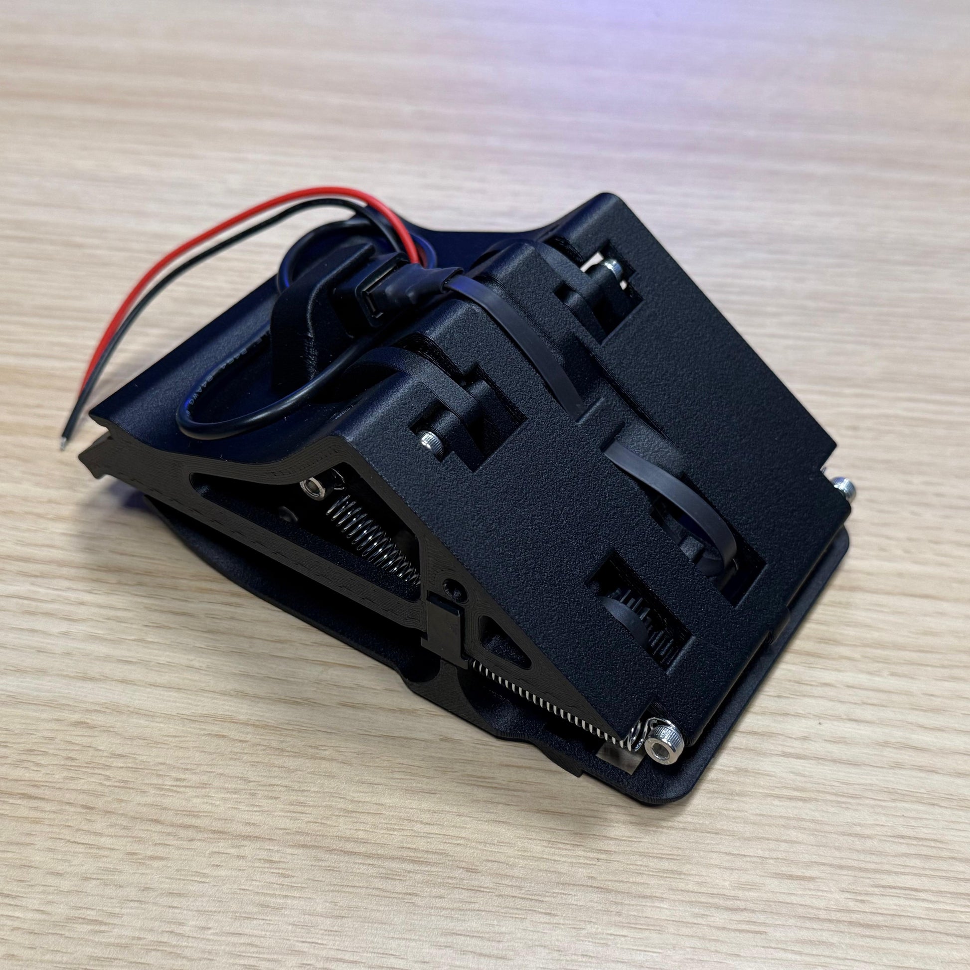 Triebwerk DTW phone mount detail — fold-out mechanism on wooden table