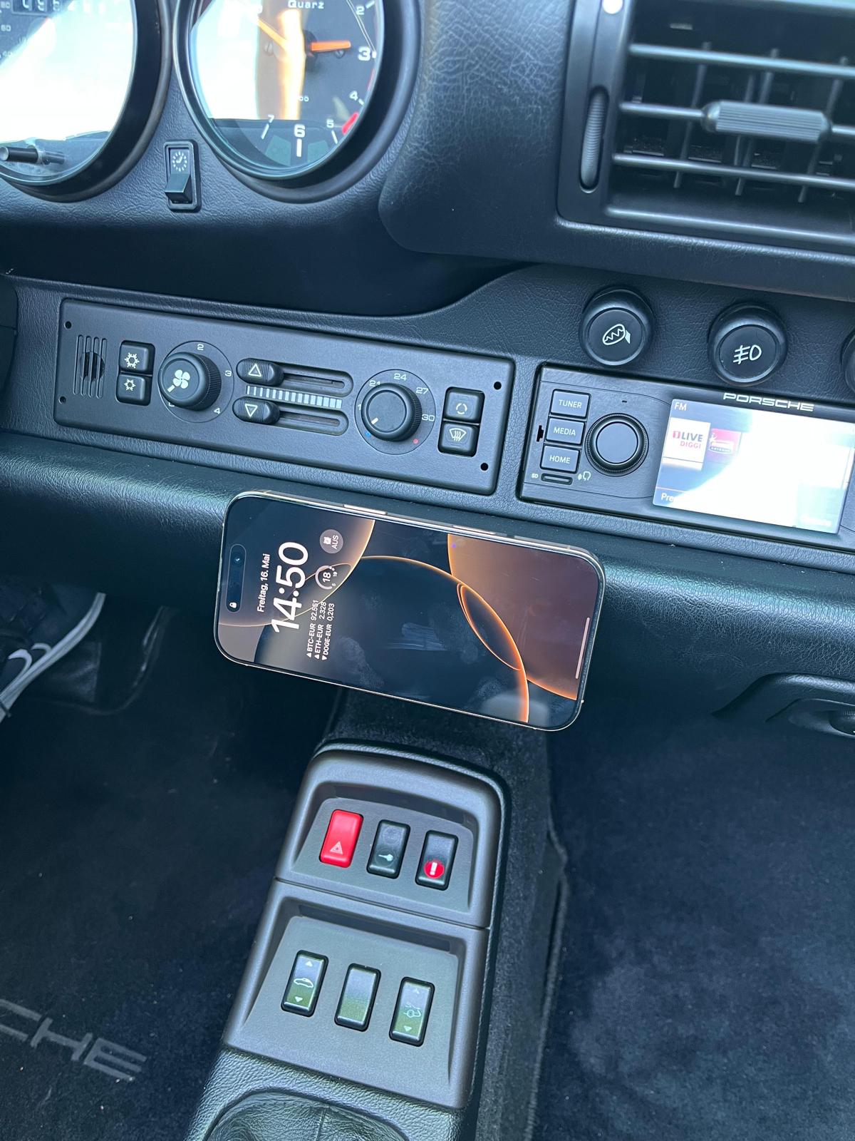 Phone mounted in Triebwerk wireless charging holder in Porsche 993 interior