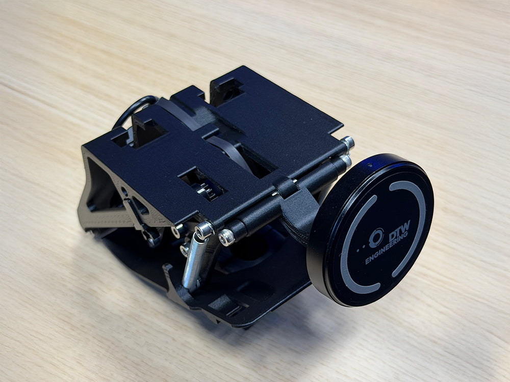 Triebwerk fold-out smartphone holder for Porsche 964 and 993 on wooden table background.