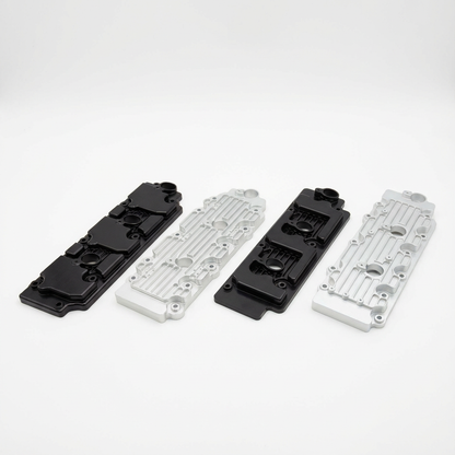 Metal valve covers in black and silver on white background