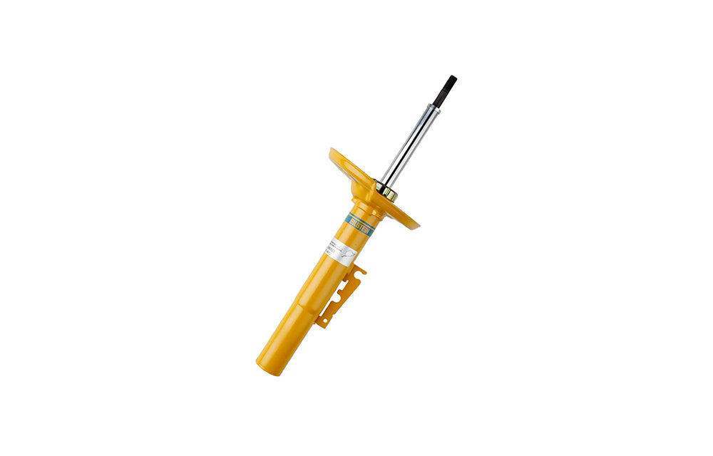Yellow Bilstein shock absorber for Porsche on white background.