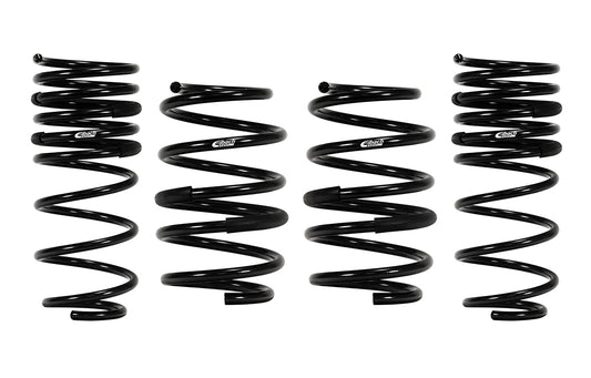 Four black Eibach pro-kit lowering springs on a white background.