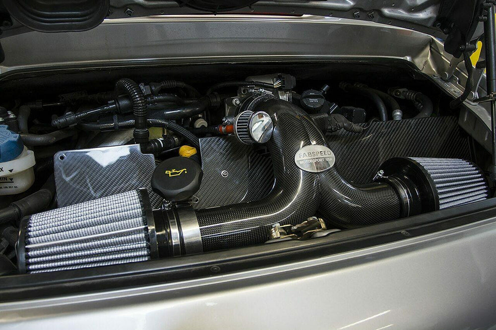 Fabspeed air intake system with carbon fiber heat shield installed in a Porsche 996 engine bay.