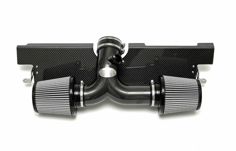 Fabspeed air intake system with carbon fiber finish for Porsche on a white background.
