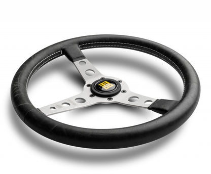 Momo heritage prototipo steering wheel  black with silver center spokes in white background.