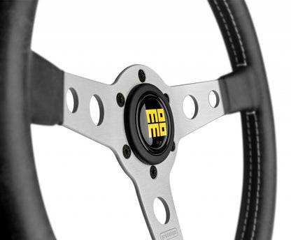 Close up of Momo heritage prototipo steering wheel silver center with momo horn button in yellow.