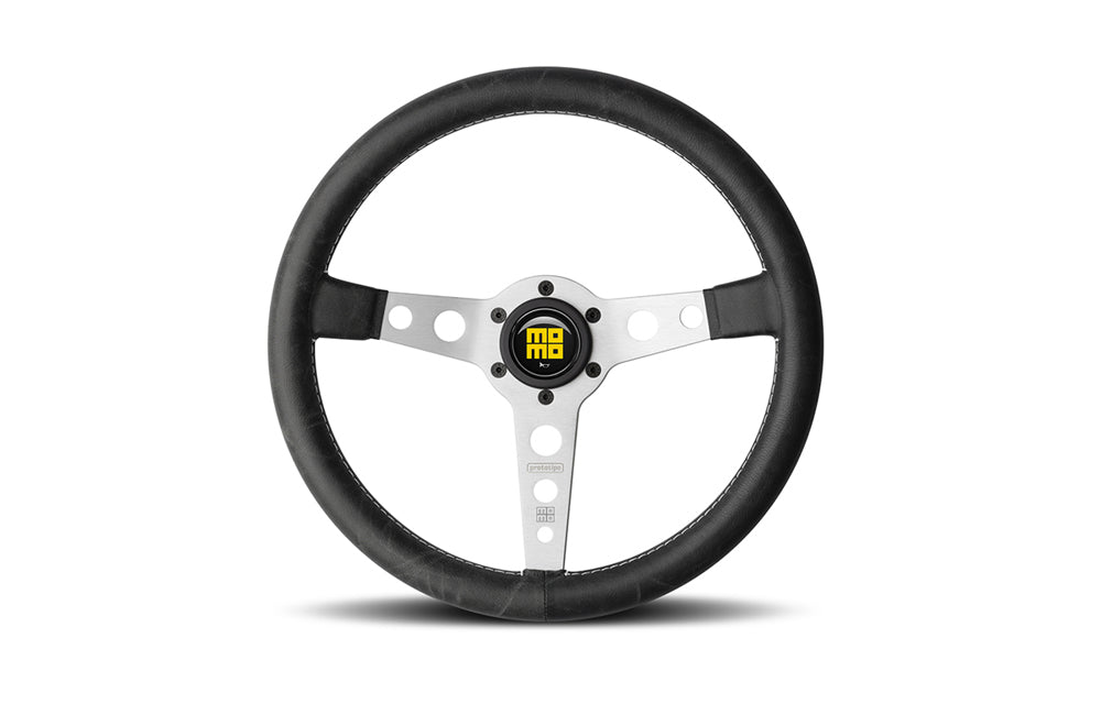 Momo heritage prototipo steering wheel  with silver center spokes in black in white background.