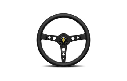Black spoke Momo Prototipo racing steering wheel with a logo on a white background.