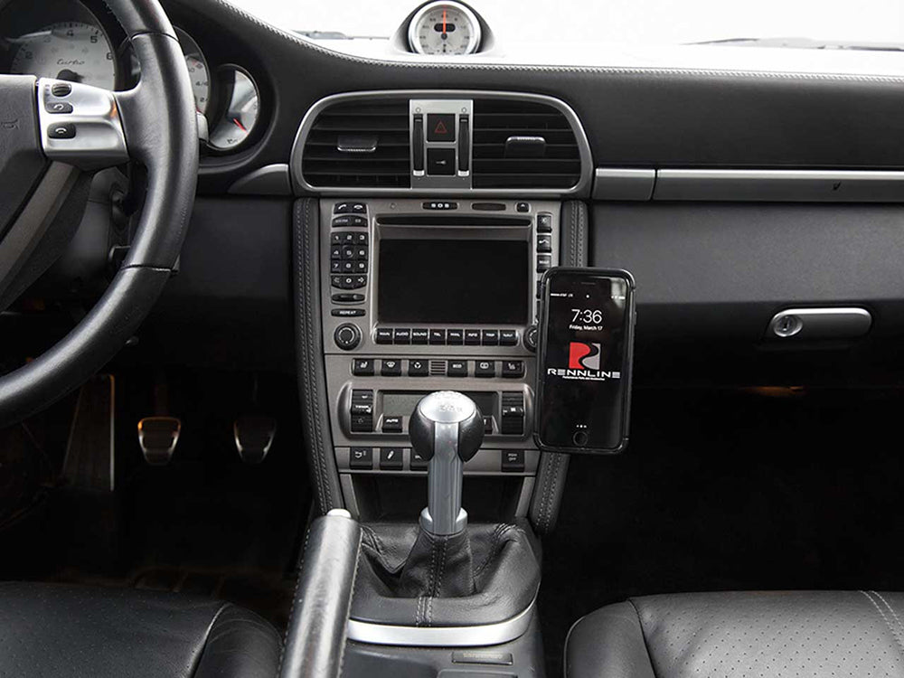 Porsche interior with a smartphone mounted on Rennline black magnetic car holder.
