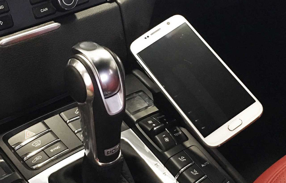Rennline magnetic phone mount installed in center console of Porsche Macan.