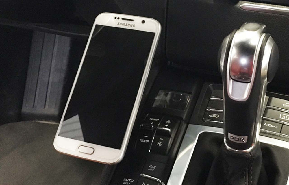 Rennline magnetic phone mount installed in left side center console of Porsche Macan.