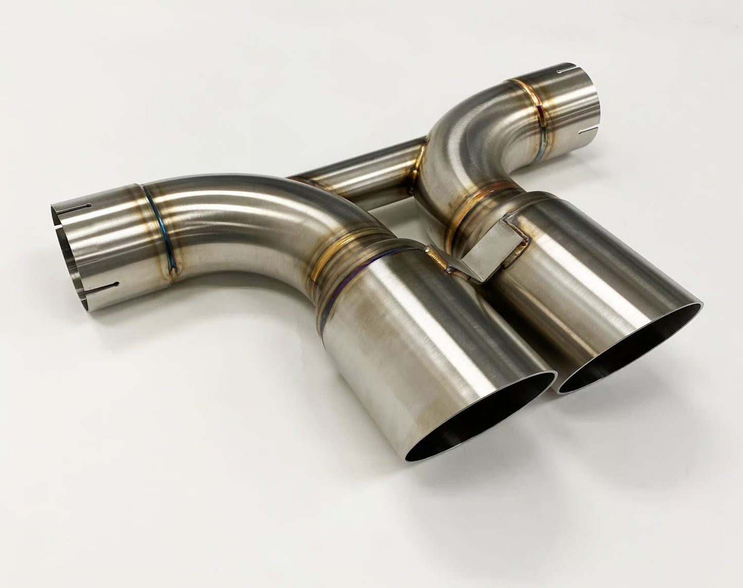 Shark Werks titanium center muffler bypass exhaust with exhaust tips on white background.