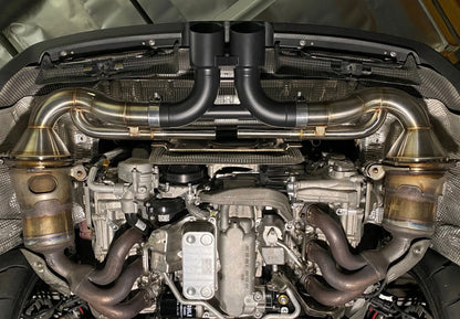 Shark Werks titanium center muffler bypass exhaust with black exhaust tips installed on Porsche 911 GT3 engine.
