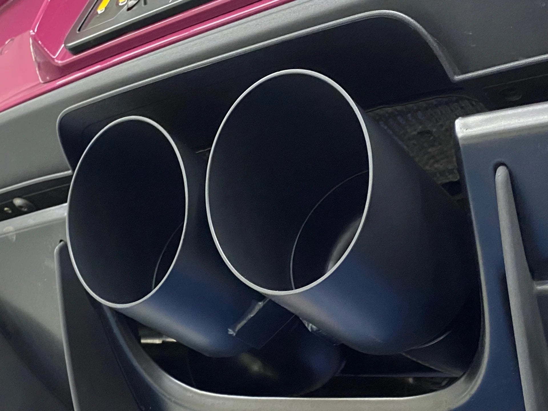 Close up of Shark Werks titanium center muffler bypass exhaust with exhaust tips installed on Porsche.